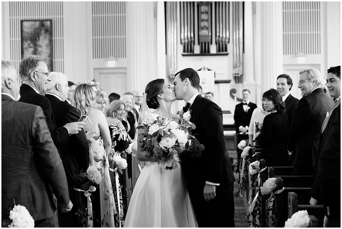 newlywed couple walking up the aisle of presbyterian church