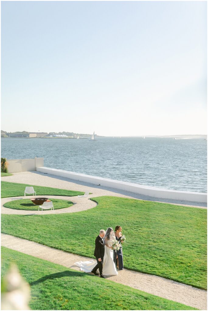 Bride walking down the aisle at a waterfront wedding at Belle Mer in Newport, RI